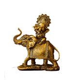 Gold statue of a person riding an elephant on a white background