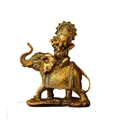 Gold statue of a person riding an elephant on a white background