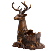 Decorative deer sculpture on a table with a living room background