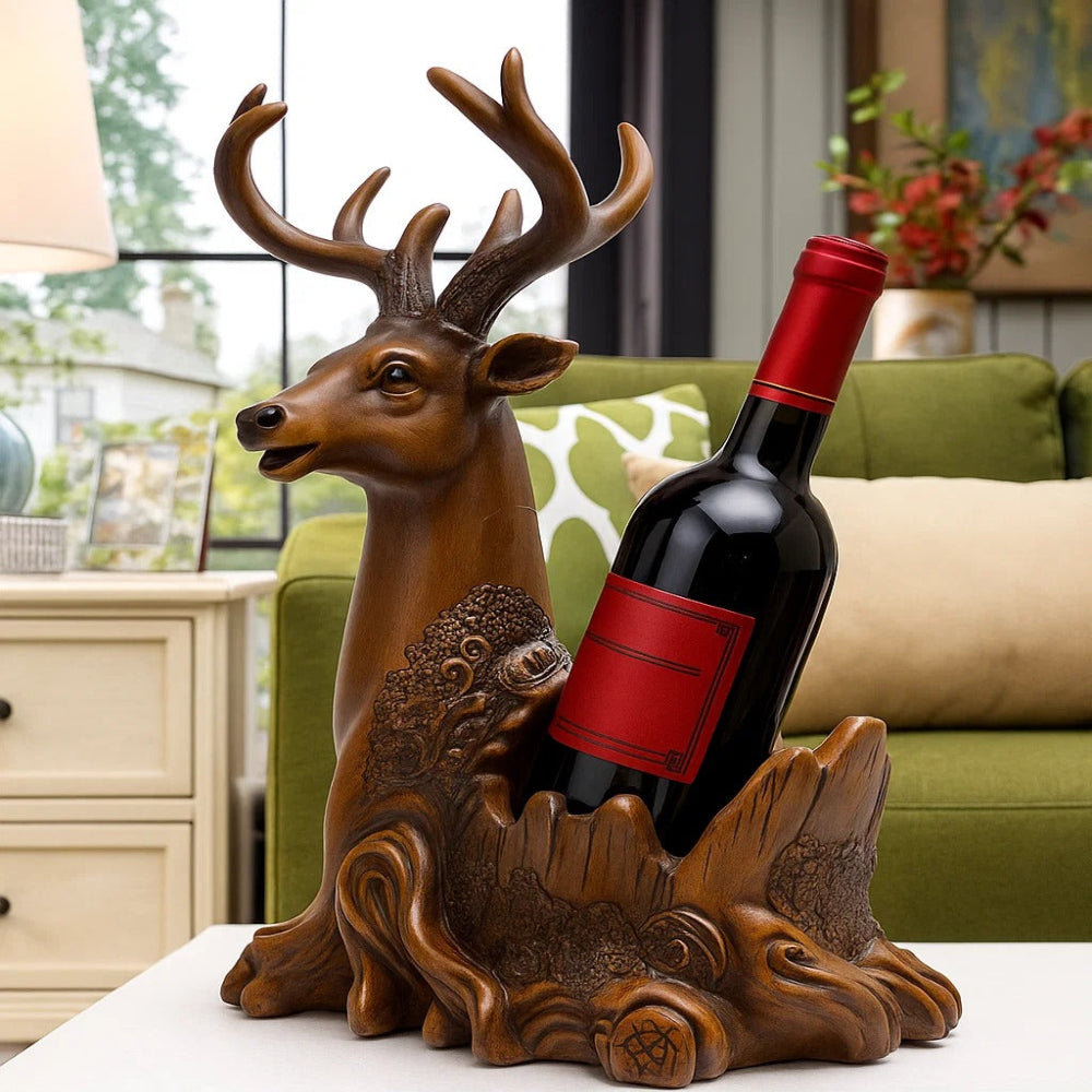 Decorative deer-shaped wine bottle holder with a red wine bottle inside, placed on a surface with a blurred background.